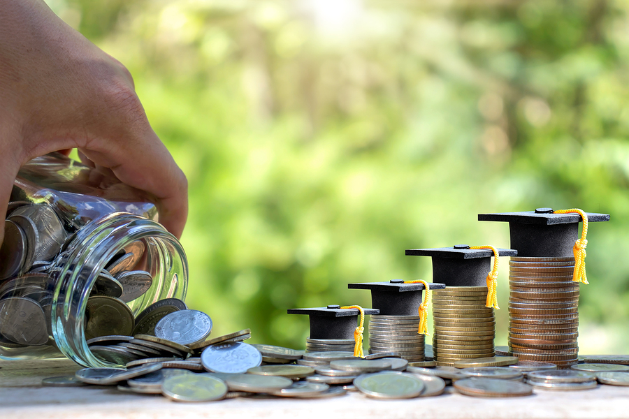 Stacks of coins with mortarboard hats