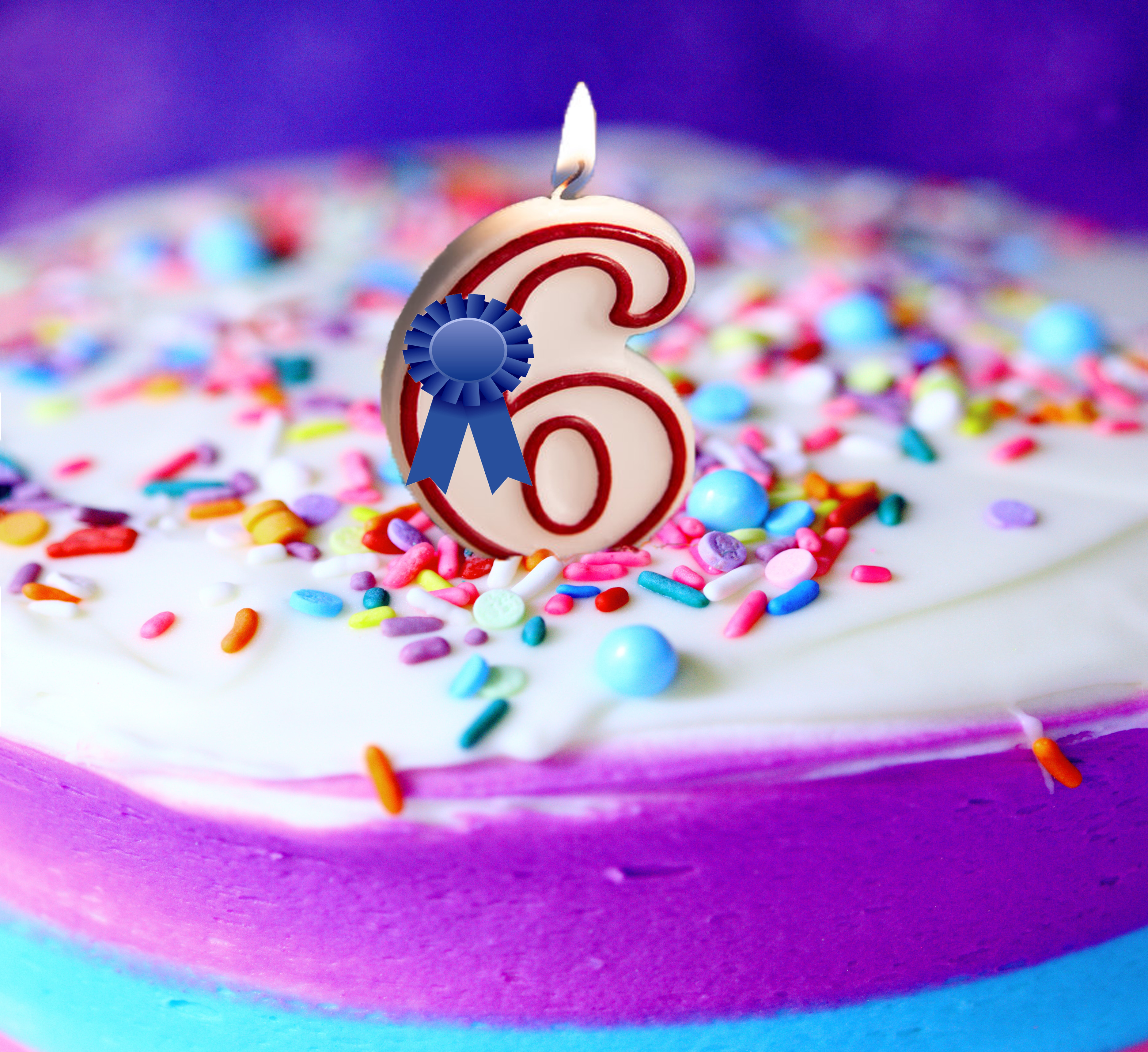 Birthday cake with 6 candle and blue ribbon